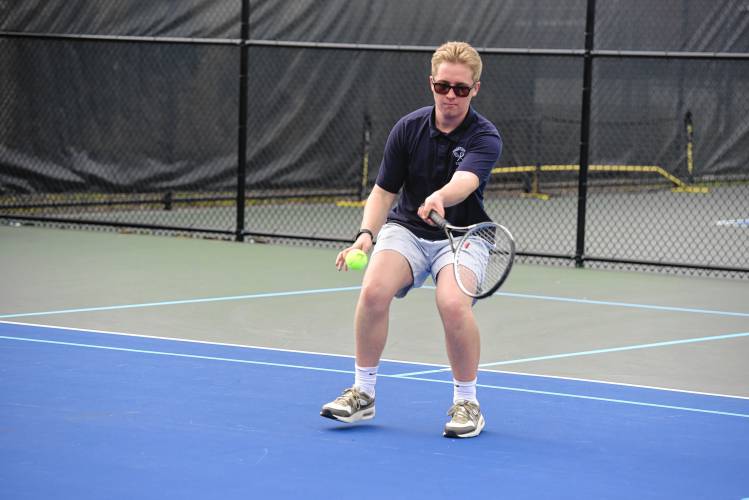 Frontier’s Robert Fuqua volleys the ball back in a No. 2 singles match against Pope Francis on Monday in South Deerfield. 