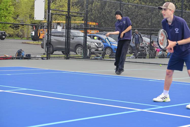 Frontier’s Brayden Reipold (left) returns a serve while his partner, Oliver Brown, looks on during a No. 1 doubles against Pope Francis on Monday in South Deerfield. 