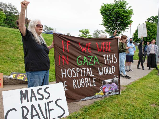 Conway resident Priscilla Lynch holds a sign with Greenfield resident Emily Greene at a rally protesting the destruction of health care in Gaza in front of Baystate Medical Center in Springfield on Tuesday morning.