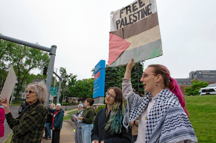 Celadry June holds a “free Palestine” sign at a rally protesting the destruction of health care in Gaza in front of Baystate Medical Center in Springfield  Tuesday morning.