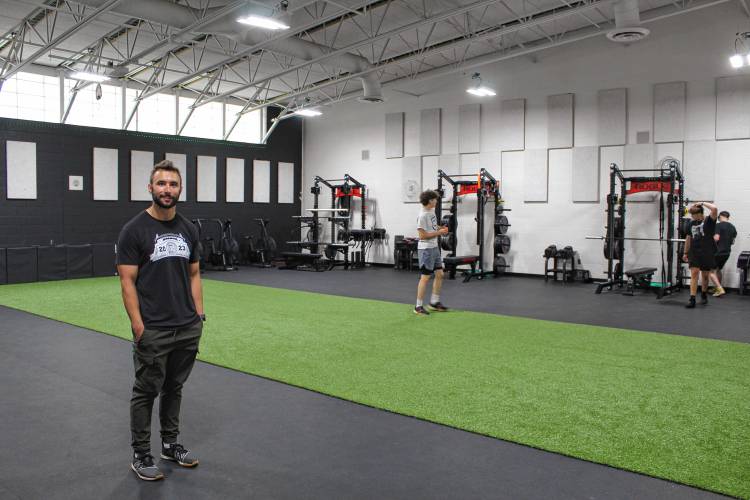 Pioneer Valley Regional School physical education teacher and Assistant Athletic Director Nick Adams stands in the school’s newly renovated auxiliary gym.