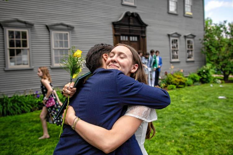 Graduate Kaelin Creagh of Deerfield shares a hug with a loved one during Deerfield Academy’s commencement ceremony on Sunday morning.