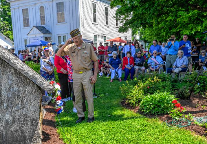 A member of the Hale-Clapp Veterans of Foreign Wars Post 3295 honor guard salutes after placing a wreath at the Whately War Memorial during the Whately Memorial Day parade on Sunday.