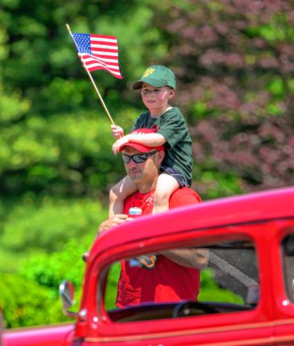 Whately resident Levi Schrader, 4, gets a shoulder ride from his father, Jake Schrader, during the Whately Memorial Day parade on Sunday.