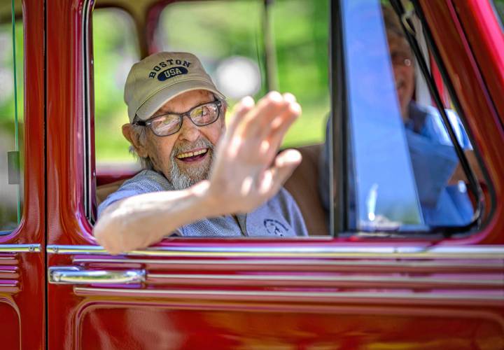 Whately resident and World War II veteran Walter Harubin, 103, waves while participating in Whately’s Memorial Day parade on Sunday.