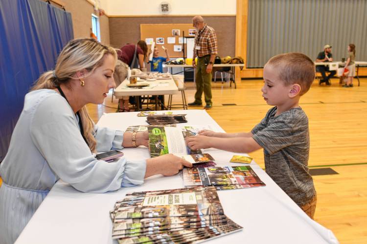 Jessye Deane, executive director of the Franklin County Chamber of Commerce, talks with preschooler Teddy Balawick about her job at “That’s a Cool Job” Day on Wednesday.