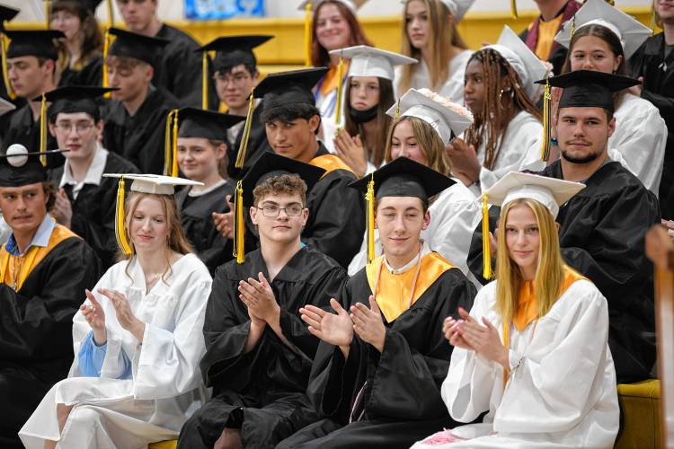 Pioneer Valley Regional School graduates applaud during the commencement ceremony on Friday night.