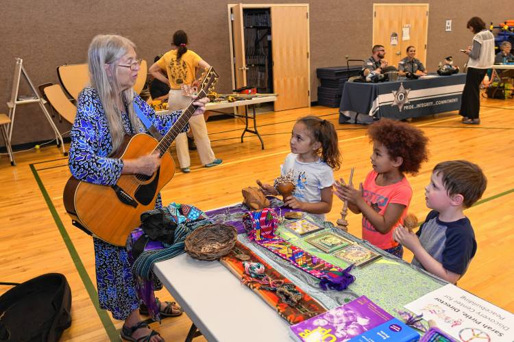 Musician Sarah Pirtle plays music for students at Rowe Elementary School for “That’s a Cool Job” Day on Wednesday.