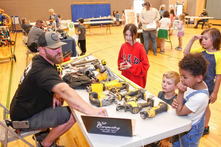 Builder Sam Lane talks about his job at “That’s a Cool Job” Day on Wednesday at Rowe Elementary School.