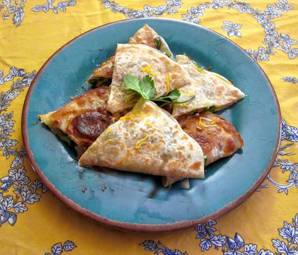 An asparadilla: a quesadilla that contains asparagus, red onion, cheese, prosciuto and cilantro.