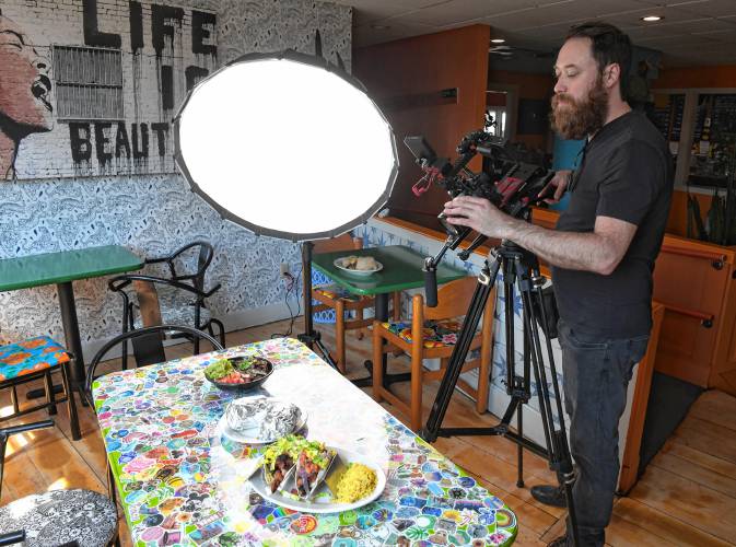 Videographer Jon Van Dyke of America’s Best Restaurants films entrees at Mesa Verde in Greenfield on Tuesday.