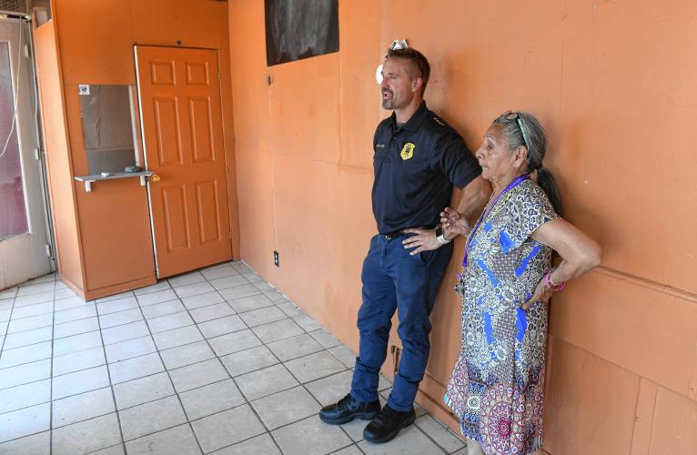 Greenfield acting Police Chief Todd Dodge talks with Maria Burge, who may help staff a substation for police to have a downtown presence at 205 Main St. 