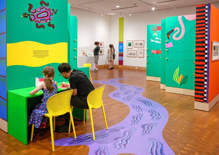 Emily DeMartino and her daughter Lyra, 6, create drawings to add to “Fuzuê! Invention & Imagination in the Art of Roger Mello” at the Eric Carle Museum. It’s the first U.S. exhibit for Mello, a Brazilian illustrator and children’s author.