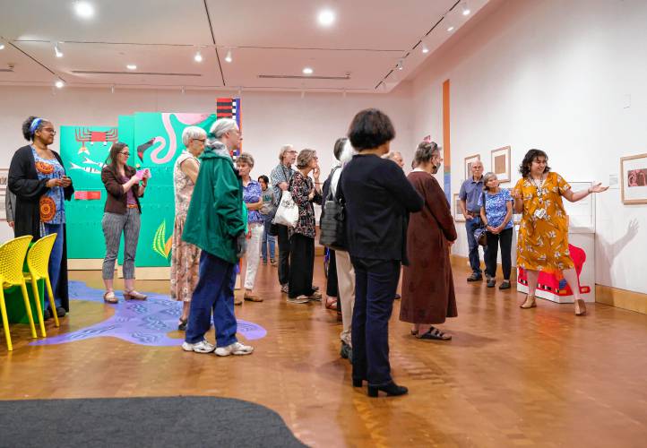 Assistant curator Isabelle Ruiz Cano leads a tour of “Fuzuê! Invention & Imagination in the Art of Roger Mello” at the Eric Carle Museum. It’s the first U.S. exhibit for Mello, a Brazilian illustrator and children’s author.