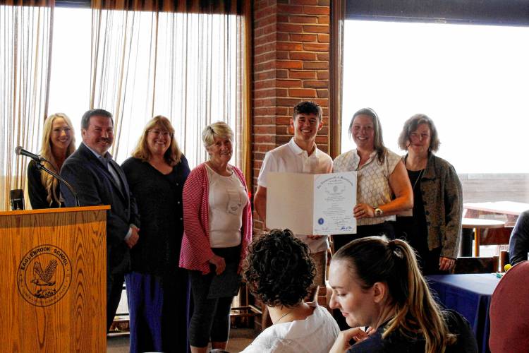 Greenfield resident Sam Whitney, who received the 2024 Young Community Leader Award, was presented with a citation from the Massachusetts House and Senate at Eaglebrook School in Deerfield on Friday morning. From left, Franklin County Chamber of Commerce Executive Director Jessye Deane, state Reps. Aaron Saunders and Susannah Whipps, Whitney, Rep. Natalie Blais and Sen. Jo Comerford.