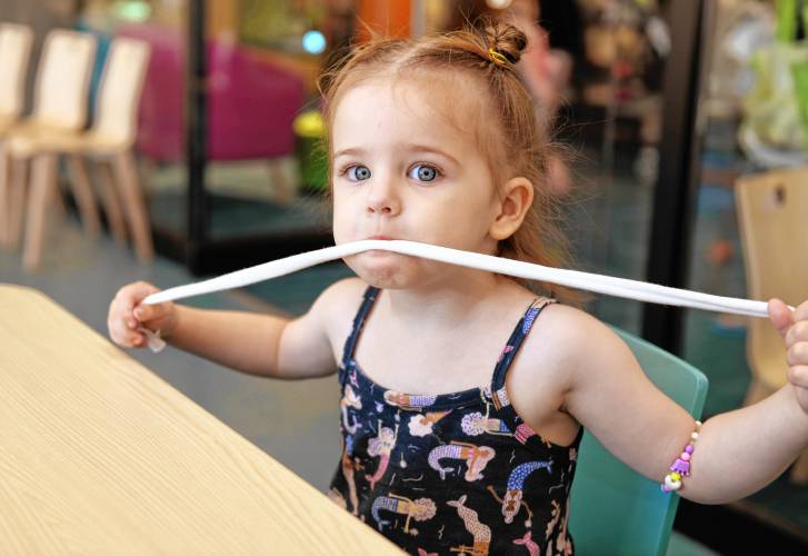 Adrienne Murphy, 2½, of Greenfield, with a fabric scrap that would soon be braided into a jump rope in the Children’s Room at the Greenfield Public Library on Tuesday. Another session will be held on Friday, July 19, at 11 a.m.