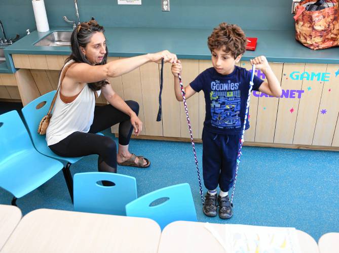 Rachel Silverman helps her son Isaiah Santos, 5, measure the braided jump rope they made at the Greenfield Public Library on Tuesday. Another session will be held on Friday, July 19, at 11 a.m.