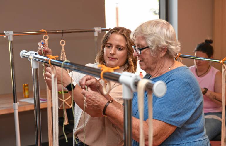 Nicole Zaccari of Springfiel, left, helps Clarita Shaffer of Greenfield start her macrame project during the first event of the The Roundhouse Craft Series.