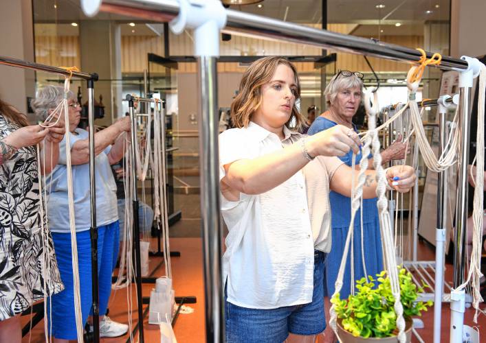 Crafters at The Roundhouse Craft Series follow Nicole Zaccari of Springfiel, center, as she demonstrates macrame knots.