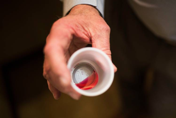 The CEO of a methadone clinic holds a 35 mg liquid dose of methadone in Rossville, Georgia, in this 2017 photo.