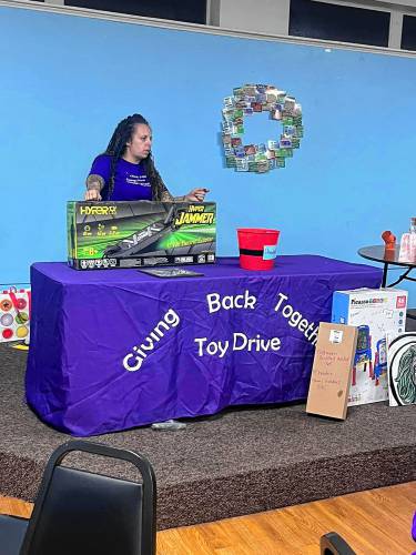 Heather Taylor, founder of the Giving Back Together Toy Drive, at a Christmas in July quarter auction fundraiser at Amvets Post 12 in Chicopee last year. A quarter auction is a combination of a raffle, auction, fundraiser and direct sales party that is similar to bingo. Participants bid on items using numbered paddles and quarters. The more paddles a participant buys, the higher their chances of having their number drawn. Another Christmas in July event is slated for July 17.