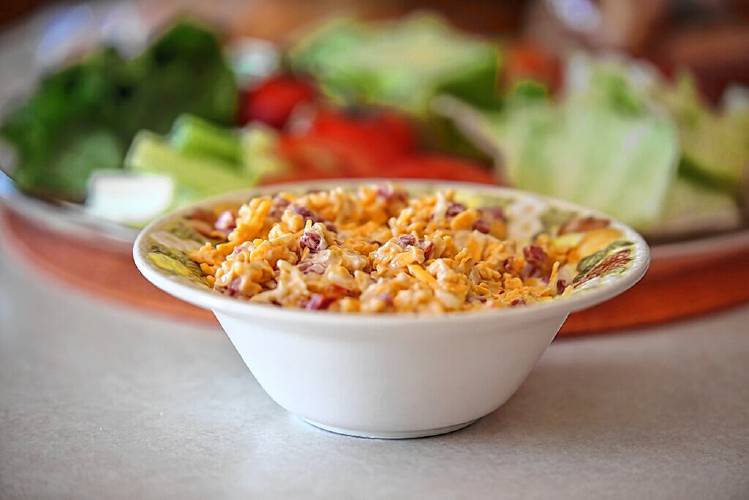 According to an article by Robert Moss in “Serious Eats,” pimiento cheese originated as “a product of industrial food manufacturing and mass marketing.”