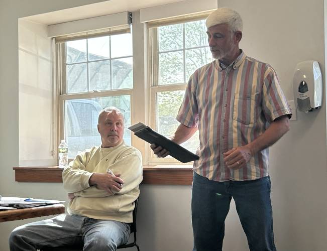 Colrain Town Administrator Kevin Fox, seated at left during a May 2023 meeting, has retired after 12 years in the role. Diana Schindler has been hired to replace him. Colrain Sewer District Commissioner and Moderator Patrick Geary is pictured at right.