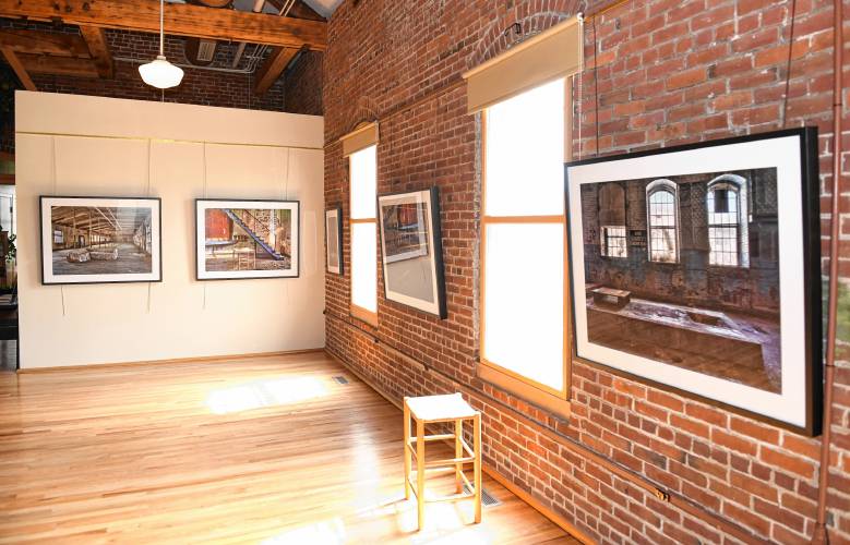 Photographs of old mill buildings by Leyden native Joe Wallace are on display in the Great Hall at the Great Falls Discovery Center in Turners Falls.