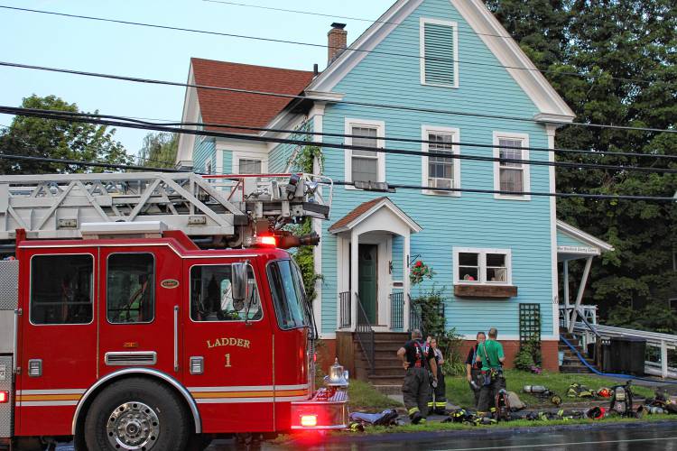 Firefighters respond to a fire at 133 South Main St. in Orange on Monday night that Fire Chief James Young says likely started due to a power line malfunction.