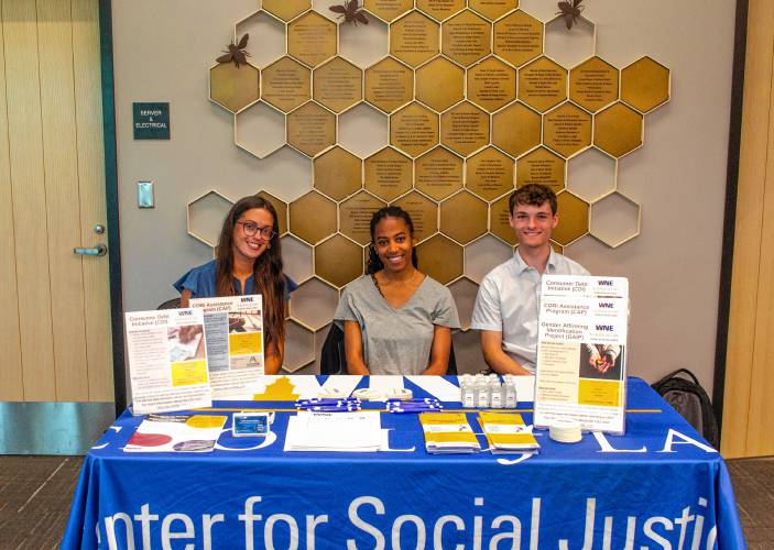 From left, Gabriella Giordano, Ava David and Thomas Carlough provide information on the new legal kiosk available at the Greenfield Public Library.