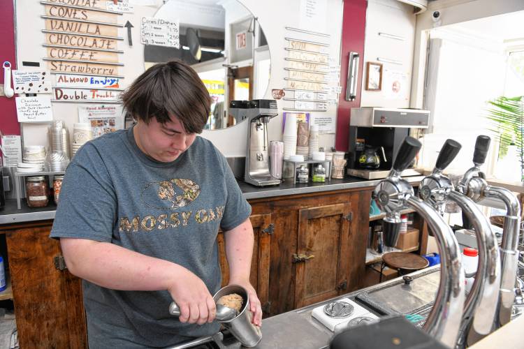 Beth Vight makes a coffee frappe with ice cream and milk at The Baker Pharmacy ice cream counter in Shelburne Falls.