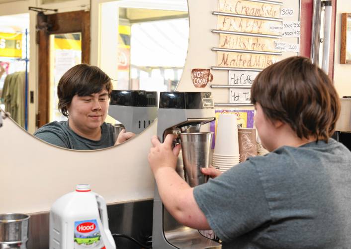 Beth Vight blends a coffee frappe, pictured below,  at The Baker Pharmacy ice cream counter in Shelburne Falls.