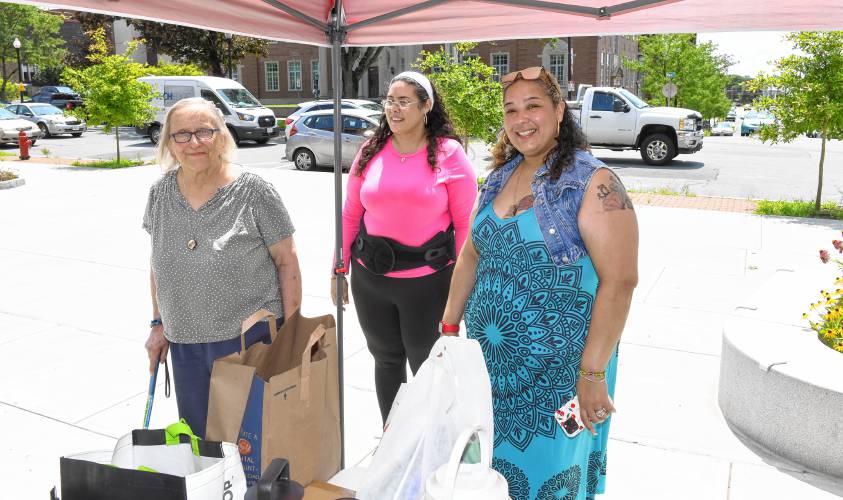 Greenfield resident Molly Chambers donated items to Patricia Toro and Shaundell Diaz of the Three County Continuum of Care on Friday during a cooling kit drive at the Greenfield Public Library to support the homeless.