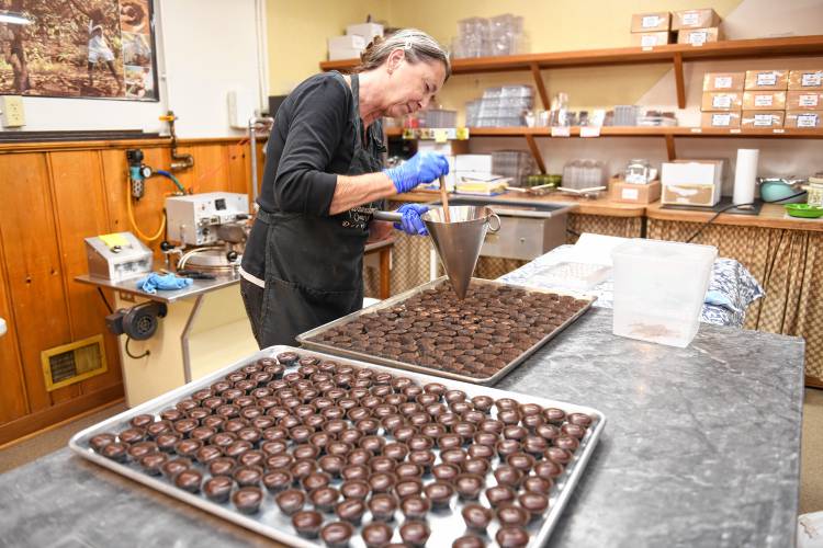 Michele Leveille fills chocolate cups at Richardson’s Candy Kitchen in Deerfield.