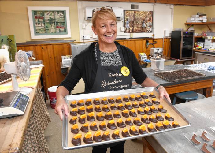 Kathie Williams of Richardson’s Candy Kitchen with candied orange slices dipped in chocolate.