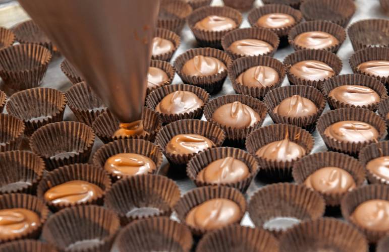 Chocolate cups are filled at Richardson’s Candy Kitchen in Deerfield.