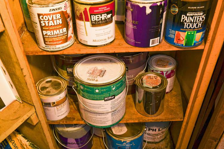 Various partially used cans of paint in a Greenfield basement. Officials in multiple Franklin County towns have been signing letters of support for “An act relative to paint recycling.”