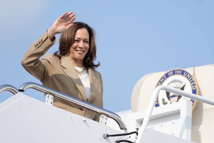 Vice President Kamala Harris waves while boarding Air Force Two as she leaves Westfield-Barnes Regional Airport in Westfield on Saturday following a political event in Pittsfield.