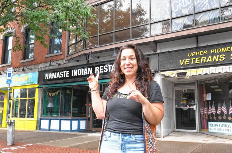 Hannah Rechtschaffen, director of the Greenfield Business Association, gestures to the GBA’s new home at 278 Main St., Suite 204, on the second floor above Namaste.