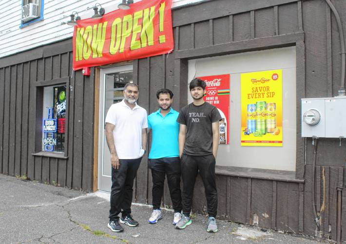 Taimoor Khan, middle, owns JC’s Market on Conway Street in Greenfield. His father Yasin Khan, left, manages the business and his younger brother Muneeb Khan, right, works there.