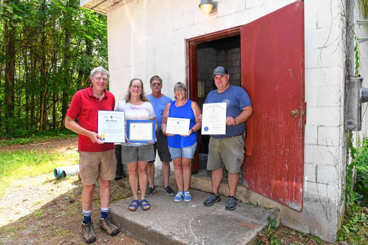 Officers of the Northfield Water District with awards they received from the state Department of Environmental Protection for providing water to Northfield residents and businesses. From left are Steve and Kathy Malsch, Jay and Teresa Nelson, and Michael Quinn.