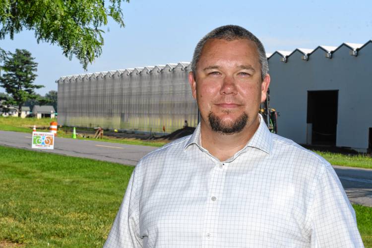 Nourse Farms CEO John Place stands by the new 2.5-acre greenhouses being built across the road from the farm’s headquarters in Whately.