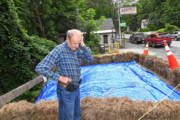 Robert Baker of Baker’s Country Store stands in what is left of the parking lot. Recent heavy rains eroded the embankment to the South River, damaging the lot and septic system and forcing them to remove fuel from their underground tanks as a precaution.