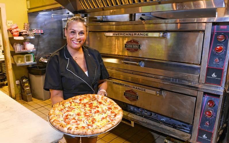 Co-owner Gaby Rowehl with a pizza at Berkshire Pizzeria in Charlemont.