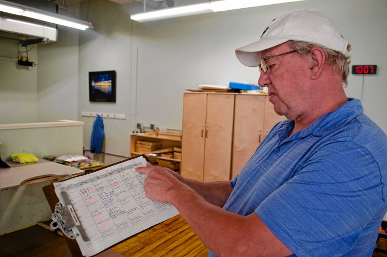 Riverside Industries employee George Joudri shows his weekly schedule during a job fair at the Easthampton nonprofit on Wednesday morning that welcomed Haitian immigrants seeking work.