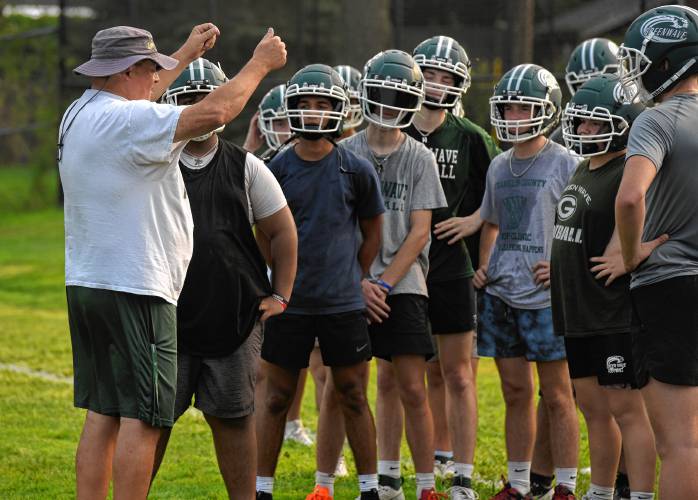 Head coach Mike Kuchieski talks to his team during Day 1 of preseason camp on Friday in preparation of their 2024 season opener on Sept. 13 against Chicopee.