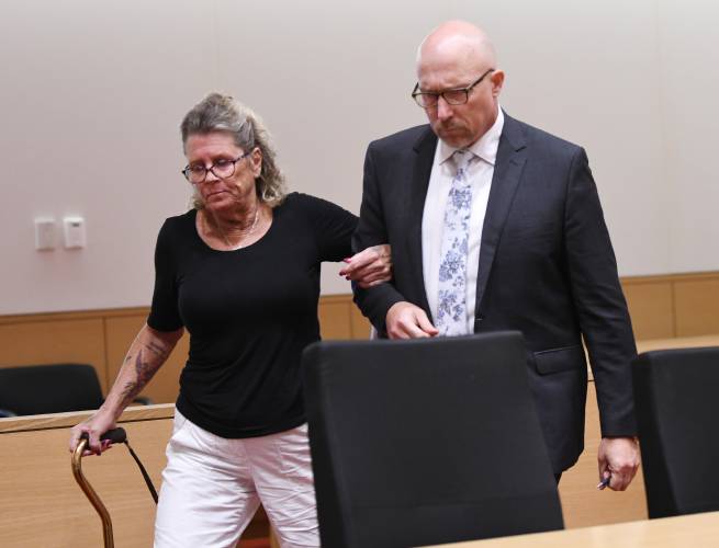 Kathleen “Kay” Doherty, who lost her leg in the Northfield crash, is escorted by Assistant District Attorney Matthew Thomas to the front of the Franklin County Superior Courtroom on Monday for a victim-impact statement.