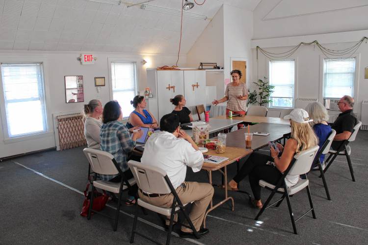 The Greenfield Business Association meets with business owners to discuss economic development in the area of Deerfield and Mill streets on Monday.