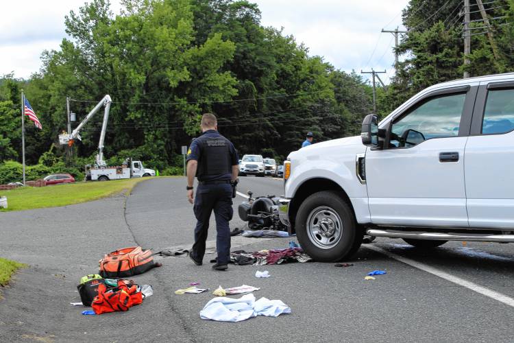 Shelburne Police investigate the site of a collision between a Honda motorcycle and a Ford F-250 on Route 2 in Shelburne on Tuesday.