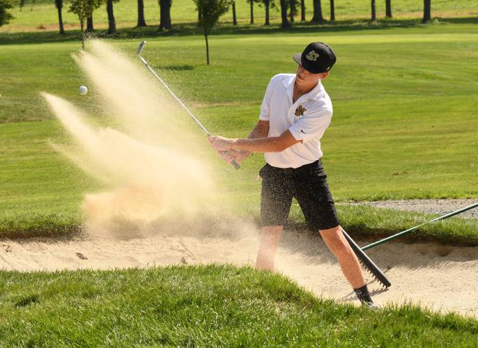 Pioneer’s Ben Werner blasts out of the bunker on the first hole against Easthampton last fall at Northfield Golf Club.